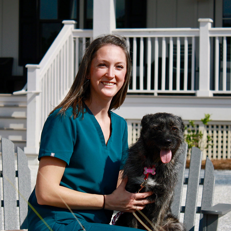 vet with dog outside posing for picture